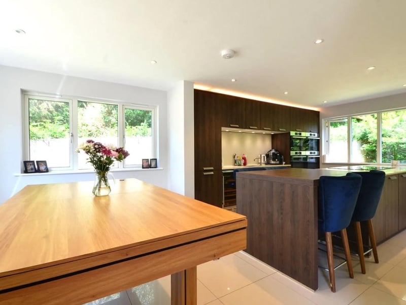 The kitchen has an island breakfast bar and dining area