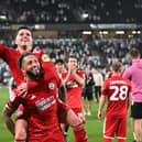 Crawley Town midfielder Liam Kelly (4) celebrates victory with Crawley Town defender Kellan Gordon (2) during the EFL Sky Bet League 2 play-off second leg match between Milton Keynes Dons and Crawley Town at stadium:mk, Milton Keynes, England on 11 May 2024 | Picture: Dennis Goodwin/ProSportsImages