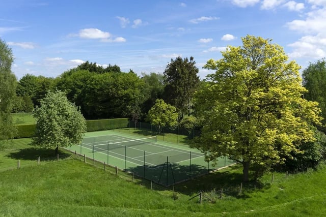 A well screened swimming pool and a tennis court are within the gardens