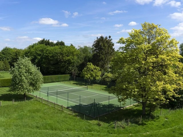A well screened swimming pool and a tennis court are within the gardens