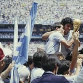 Argentina captain Diego Maradona holds aloft the trophy with a team mate after the FIFA 1986 World Cup Final against West Germany  (Photo by Allsport/Getty Images/Hulton Archive)