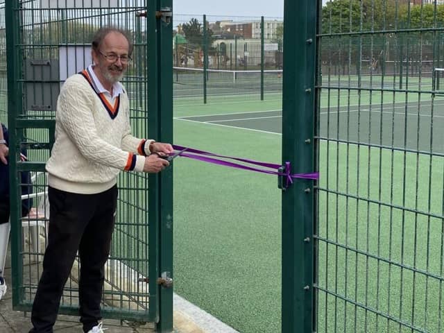 Chair Richard Carroll cuts the ribbon to reopen the courts