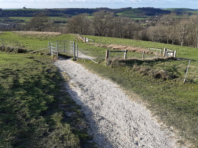 Go through the gate and continue straight ahead down the hill. Follow the path straight down.