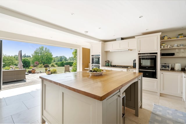The kitchen is well appointed with appliances and built-in storage