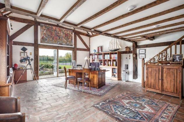 The light and airy study has doors leading to the garden with views across the tennis court