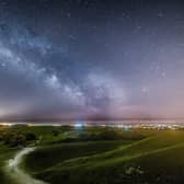 The milkyway above the lights of Worthing and Brighton from Cissbury Ring with the lights of the Rampion Wind farm in the background