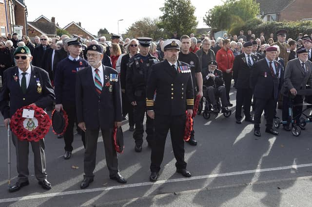 Members of the Armed Forces and various associations wait to lay their wreathes outside St. Peters Church, Selsey.