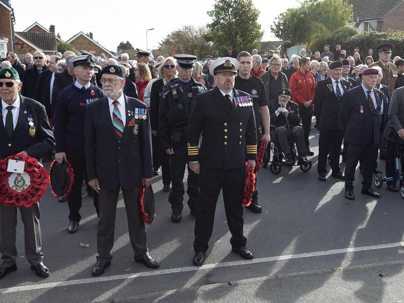 Members of the Armed Forces and various associations wait to lay their wreathes outside St. Peters Church, Selsey.