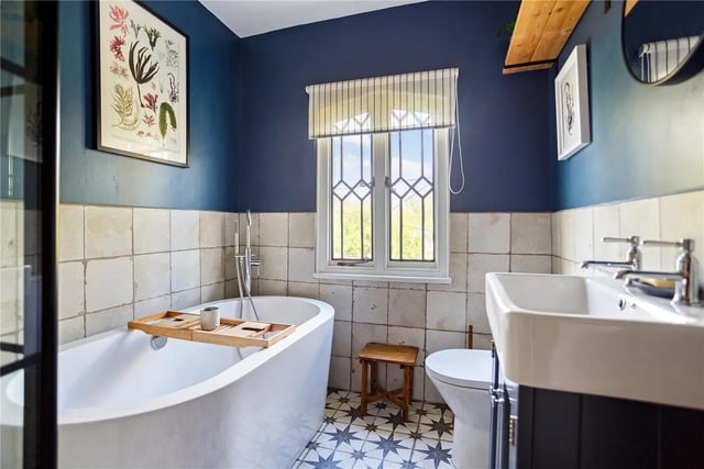 The well-appointed bathroom has plenty of character.
