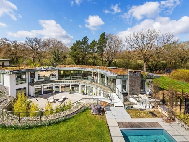 This contemporary designed house is full of home comforts, with a  cinema room, games room, gym, swimming pool with outside entertaining space, sunken courtyard, gardens and paddocks.
It is on the market for £3,000,000 with house. Covering London and The Country.