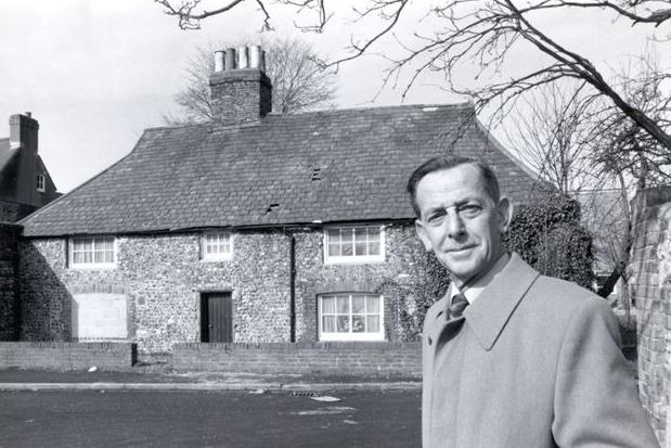 Captain Basil Divers, chairman, outside the derelict cottage, with holes in the roof, circa 1980, when the Southwick Society took over