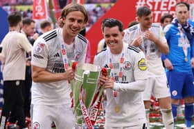 Scorers Danilo Orsi and Liam Kelly celebrate with the Sky Bet League Two Play-Off Final trophy | Photo by Paul Harding/Getty Images