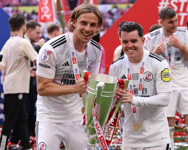 Scorers Danilo Orsi and Liam Kelly celebrate with the Sky Bet League Two Play-Off Final trophy | Photo by Paul Harding/Getty Images