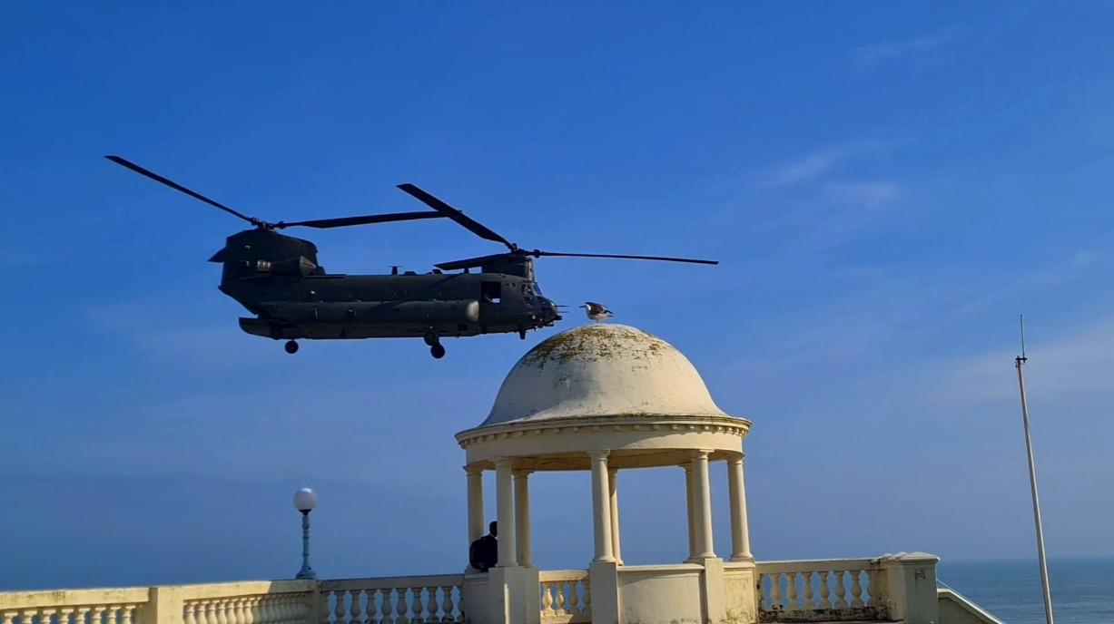 A Boeing Chinook helicopter pictured over the Bexhill De La Warr Pavilion domes