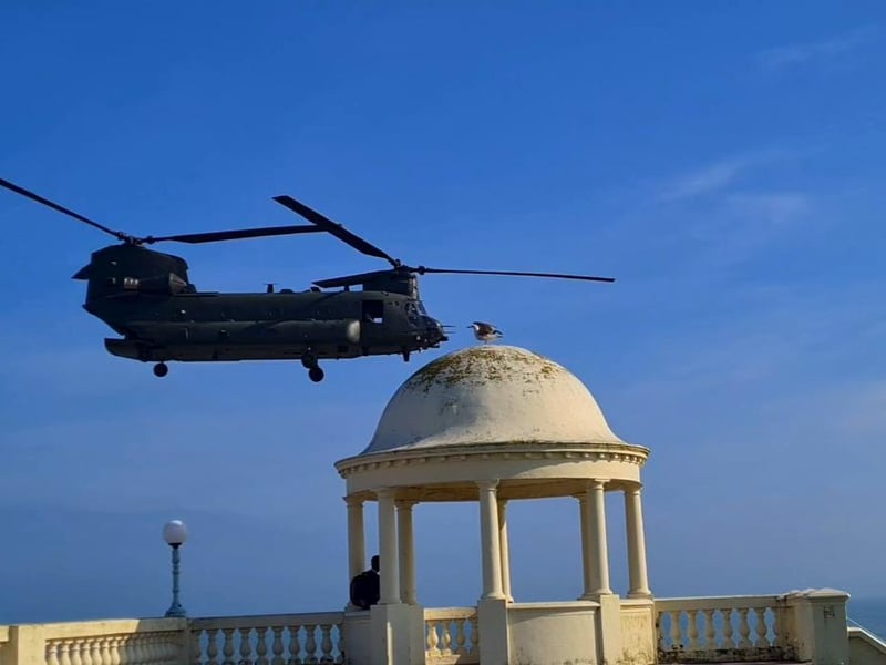 A Boeing Chinook helicopter pictured over the Bexhill De La Warr Pavilion domes