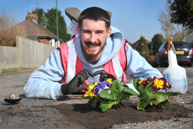 Harry Smith-Haggett planting up potholes Orchard Road, Horsham.