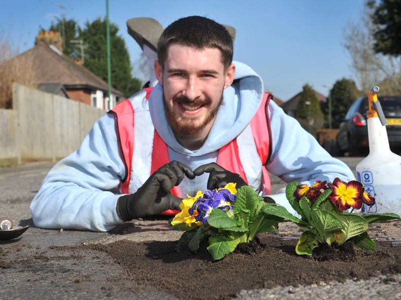 Harry Smith-Haggett planting up potholes Orchard Road, Horsham.
