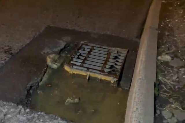 This pothole has opened up around a drain, exposing the ironwork. Picture: Eddie Mitchell