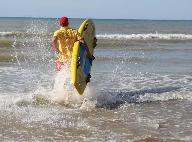 RNLI Lifeguard with board. Picture by Kt Bruce