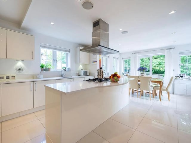 The large kitchen/dining room has a central kitchen island