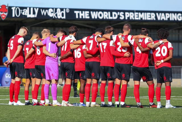 Eastbourne Borough players line up for the minute's silence to remember Queen Elizabeth II | Picture: Andy Pelling