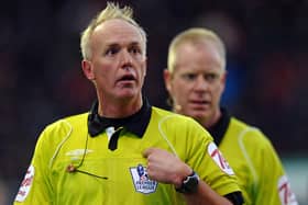 Referee Peter Walton gestures to the crowd as he leaves the field at half time in the English Premier League football match between Stoke City and Manchester City at the Britannia Stadium, Stoke-on-Trent, Staffordshire.