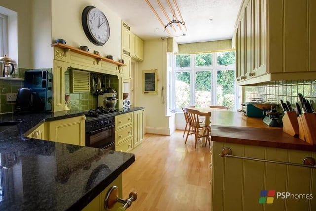 The kitchen is bespoke built and has granite and wooden worktops and space for a breakfast table