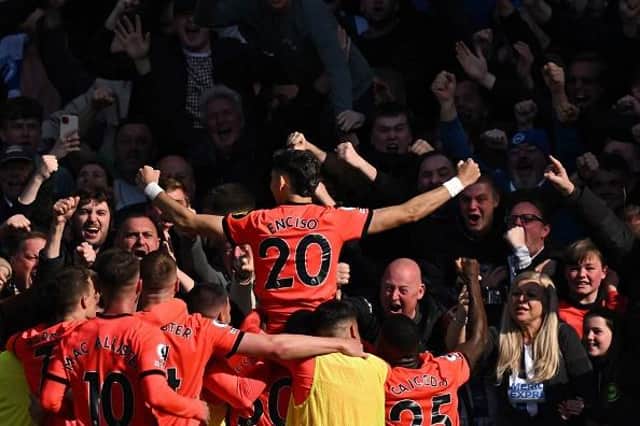 Brighton's Paraguayan striker Julio Enciso (C) celebrates with teammates after scoring their second goal at Chelsea
