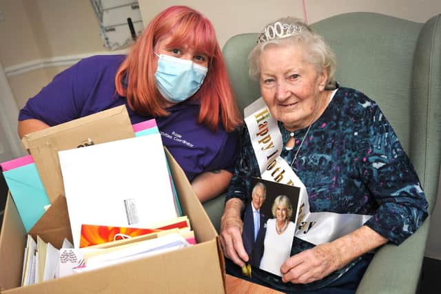 Marge Hollands celebrated her 100th birthday. Seen here with Rosie Hardy (Activities Coordinator) and some of the many birthday cards sent in to her. Pic S Robards SR2210271