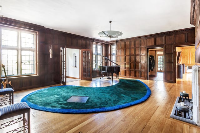 There is plenty of room for relaxation in the wood-panelled rooms such as this one currently used as music room