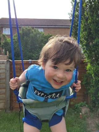 Teddy playing on a swing before his diagnosis.