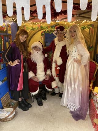 Anna, Elsa with Father Christmas and Mrs Claus