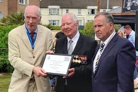 D-Day veteran Lewis Curl is awarded his Veterans Badge.