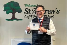 Horsham MP Sir Jeremy Quin receives a headteacher's certificate after helping St Andrew's School in Nuthurst to avoid a power cut
