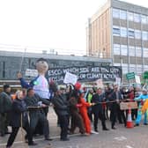 Campaigners held a tug of war outside the council buildings on Tuesday, December 6, with half representing fossil fuels and the other representing climate action.