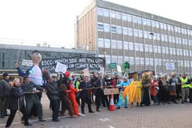 Campaigners held a tug of war outside the council buildings on Tuesday, December 6, with half representing fossil fuels and the other representing climate action.