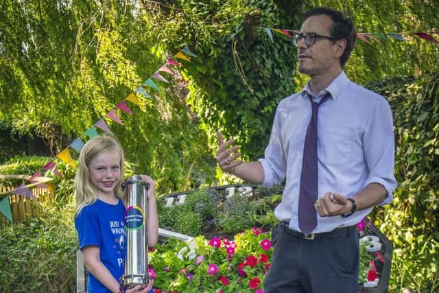 Isabelle Lurcock, 7, from Hove clutches the time capsule at Paradise Park alongside site director Darren Clift.