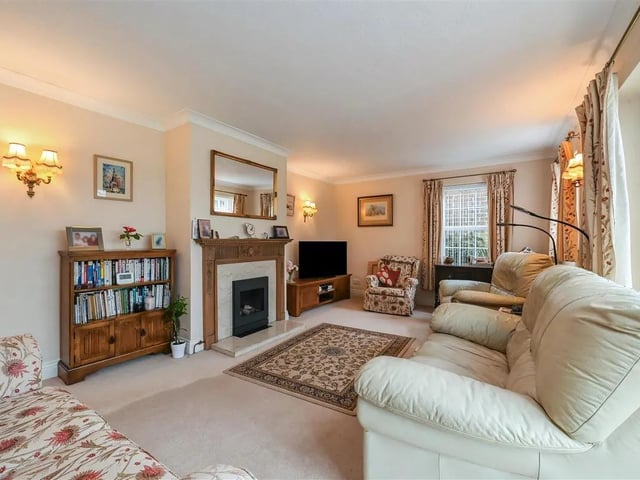 The living room benefits from a beautiful feature fireplace.