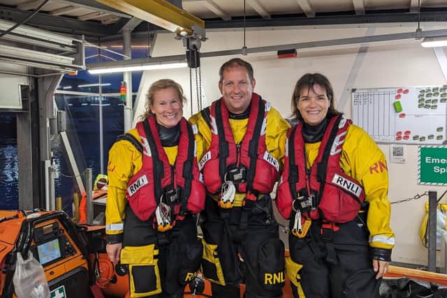 Dave Riley (middle) with other Poole RNLI volunteers. Picture from Poole RNLI
