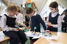 Children at Highfield and Brookham Schools use their moon buggies to test the strength of their bridge