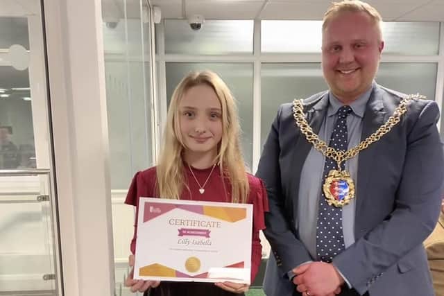 Lilly with the award she received from the Hastings Mayor