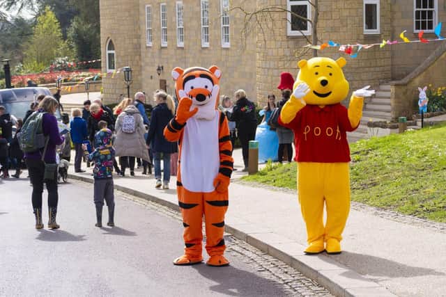 Winnie the Pooh and Tigger greeting the arriving families.