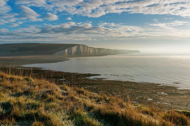 Located in East Sussex, Seven Sisters Country Park is known for its stunning white cliffs, rolling hills, and tranquil beaches.