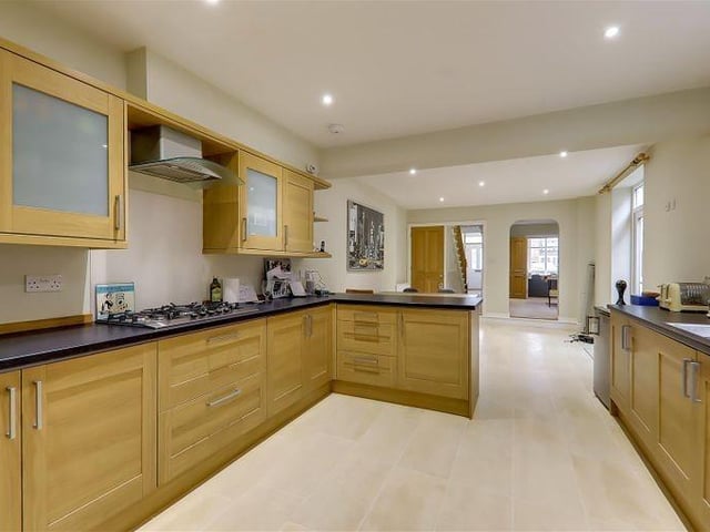 The kitchen has integrated appliances including a dishwasher, fridge freezer and split-level double oven