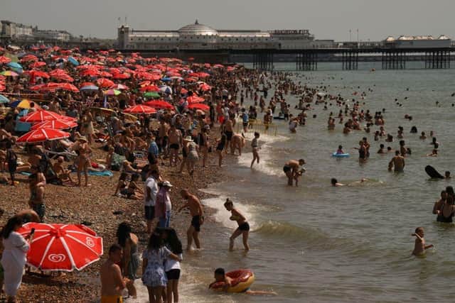 People enjoying the sunshine in Brighton (Photo by DANIEL LEAL/AFP via Getty Images)