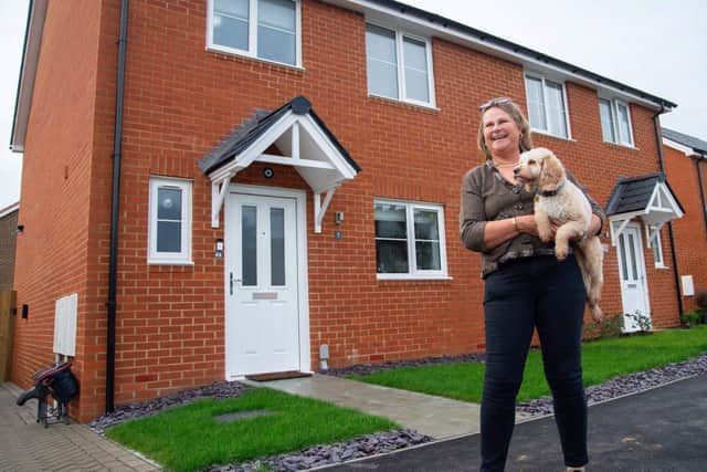 Tammy Roxburgh and her Cockapoo Nutmeg outside their new three-bedroom semi-detached house