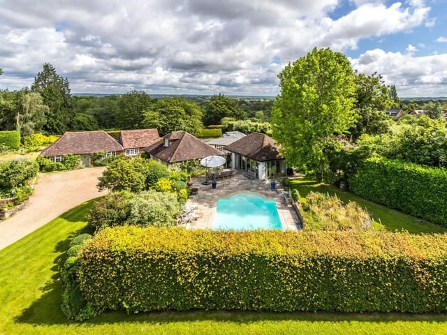 The house has a heated swimming pool, a pool house and a separate outbuilding