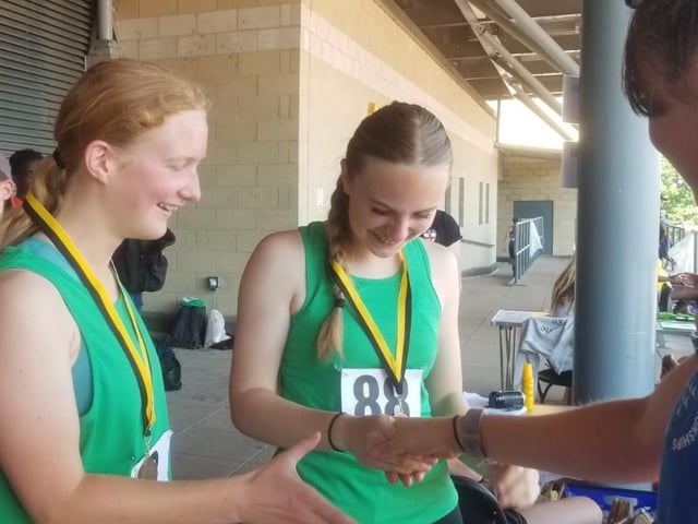 Josie Usher & Aoife Cherrill collect their medals