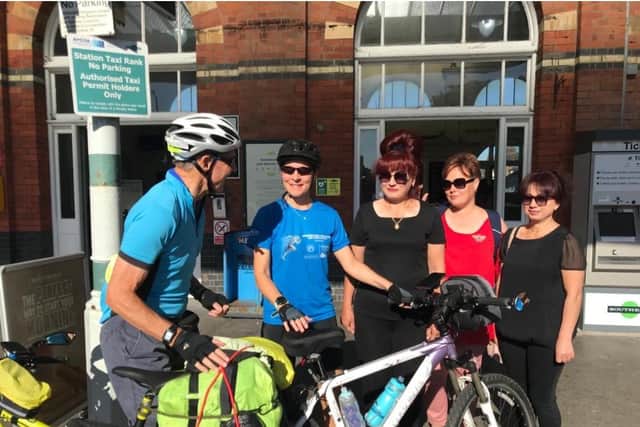 Peter and Lucy about to set off from Bexhill, pictured with some of the refugees they are supporting.