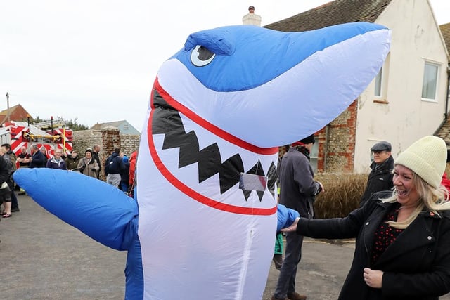 Some 385 people braved the ice cold sea water on New Year's Day 2024. Coln Miles as a shark